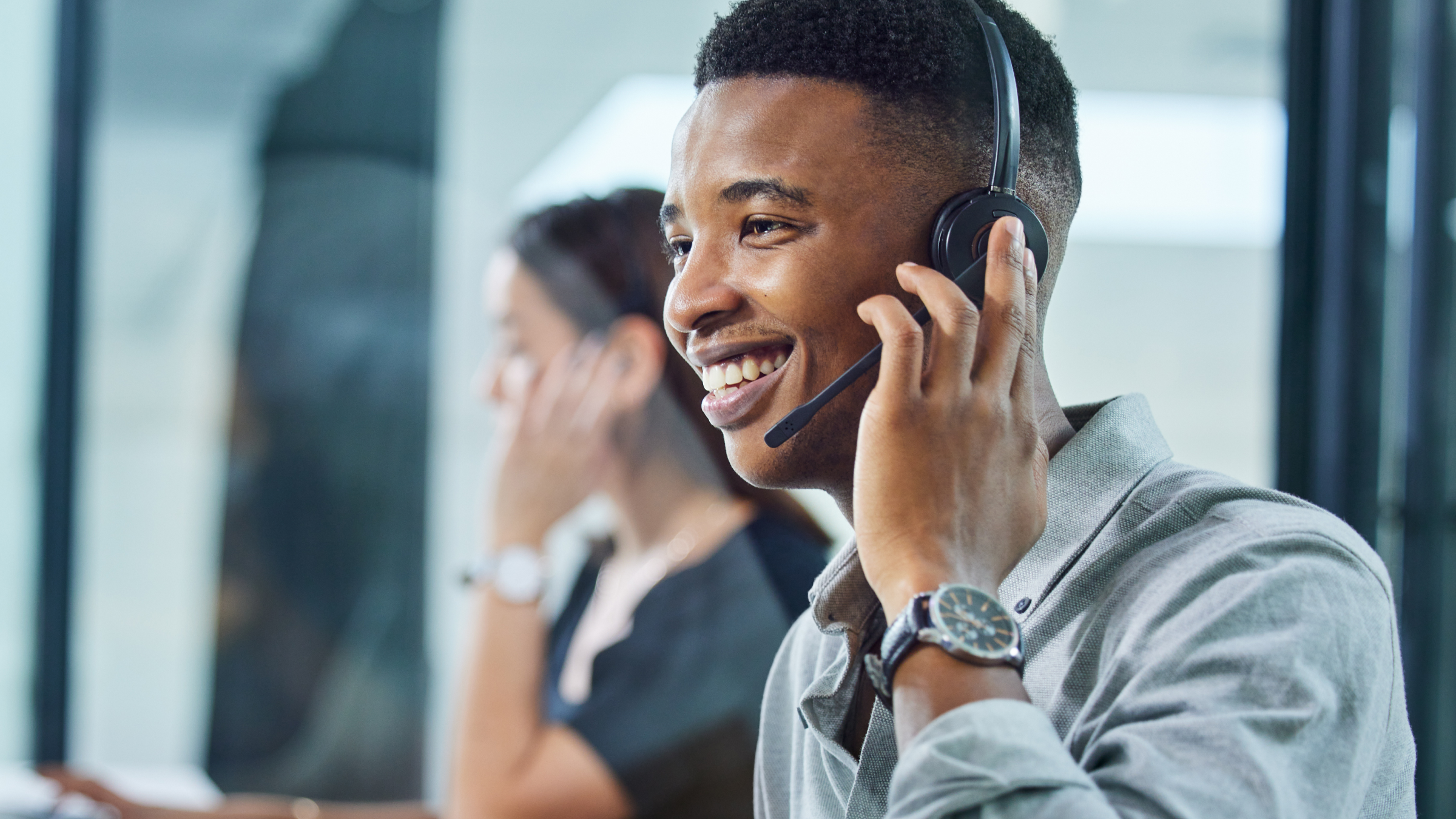 A help desk representative talking in his headset.