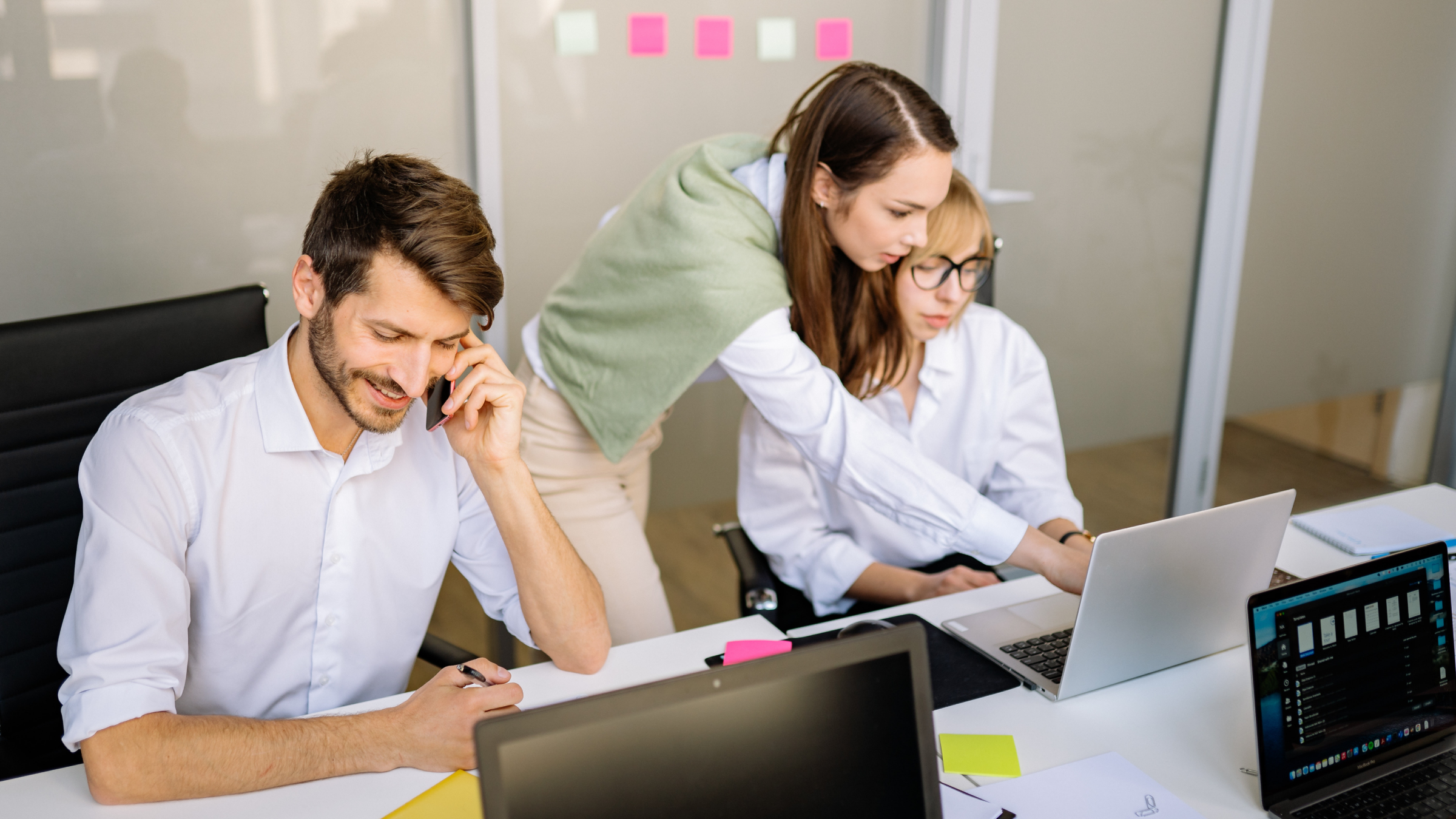 Three employees working at the office.