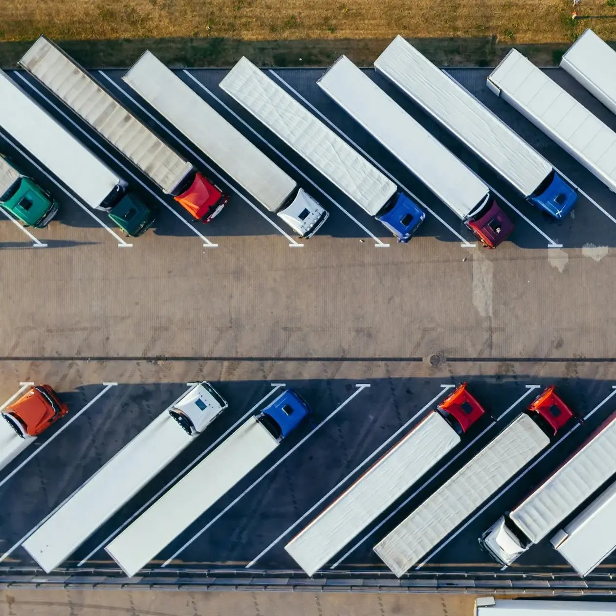 Aerial view of semi-trucks parked in a logistics center