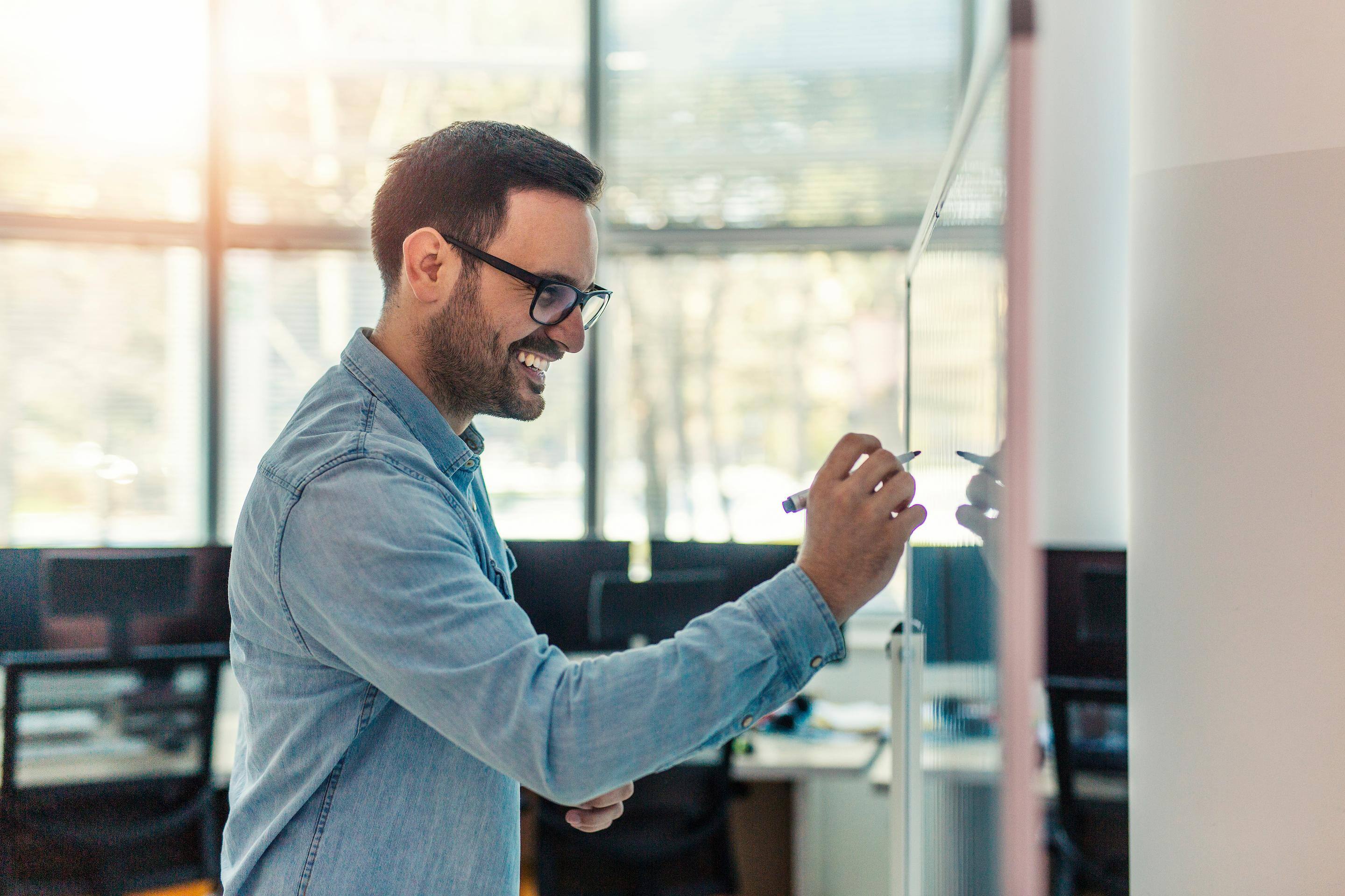 Man writing on white board