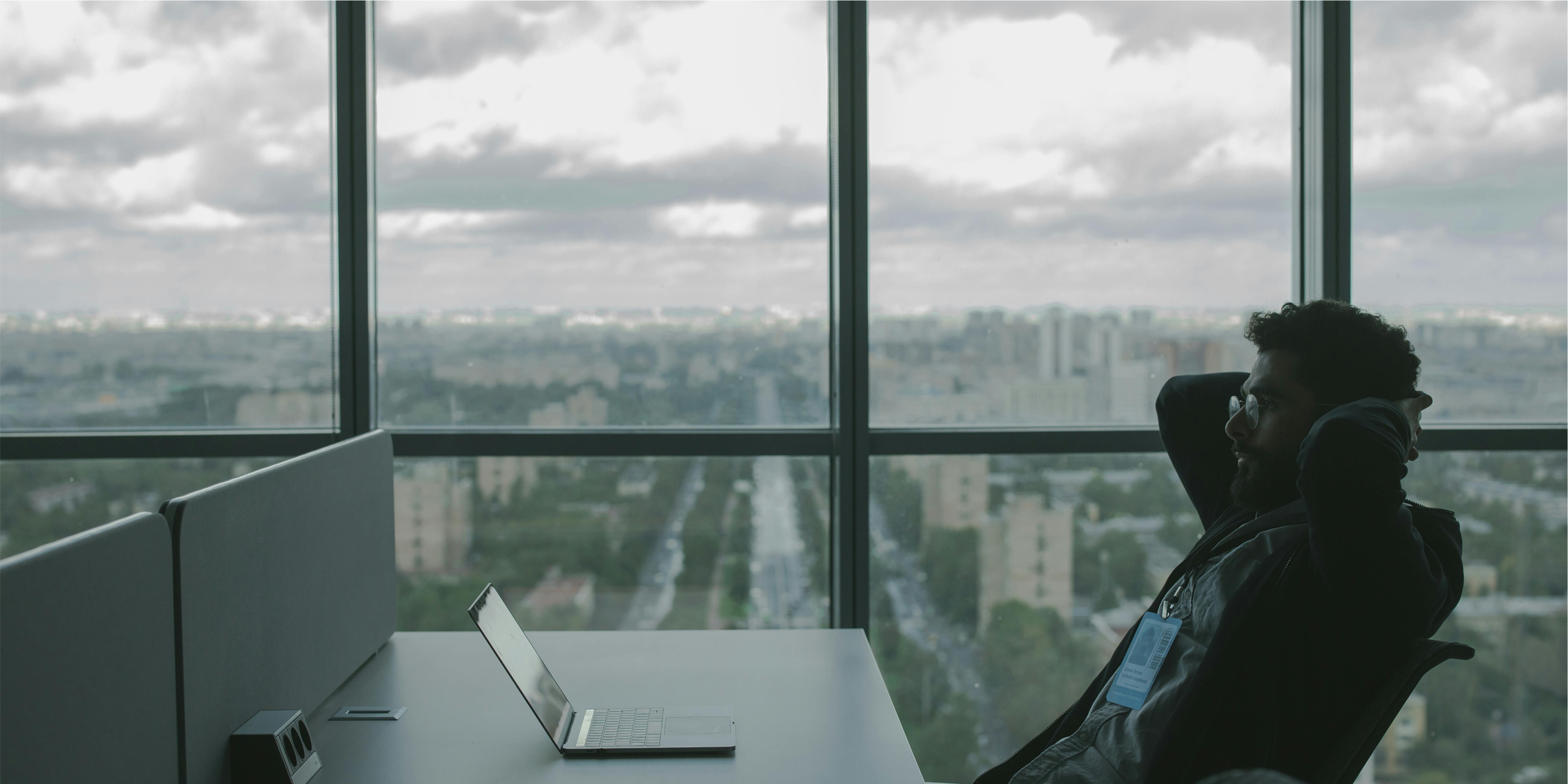 a man sit in front of his computer wondering what is going on 