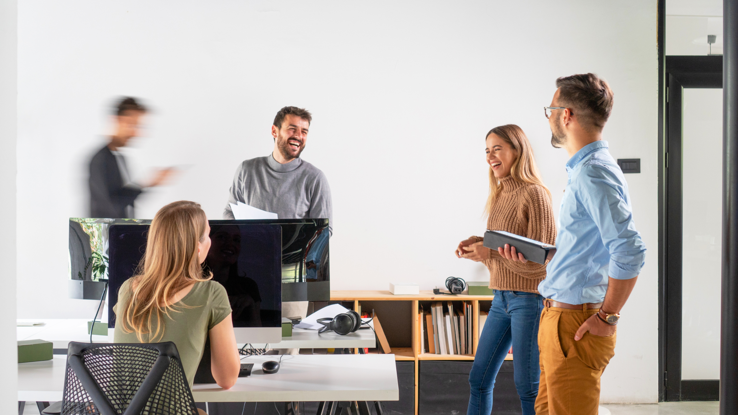 A group of employees talking to each other. 